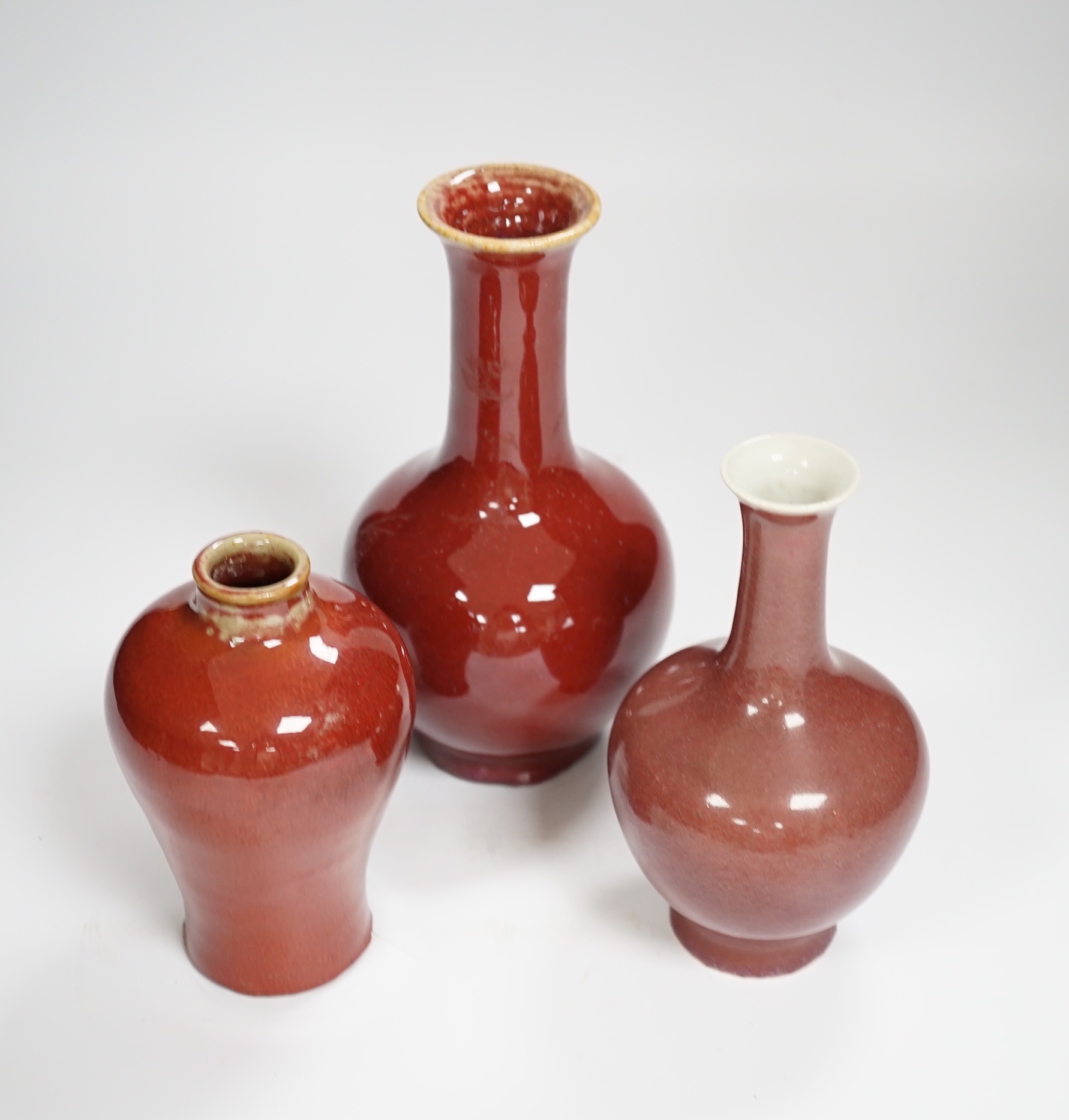 Three Chinese sang de boeuf glazed vases, largest 18cm high